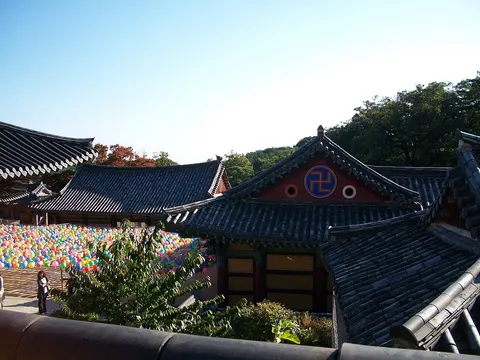 Tile roofs and courtyard lanterns at Donghwasa